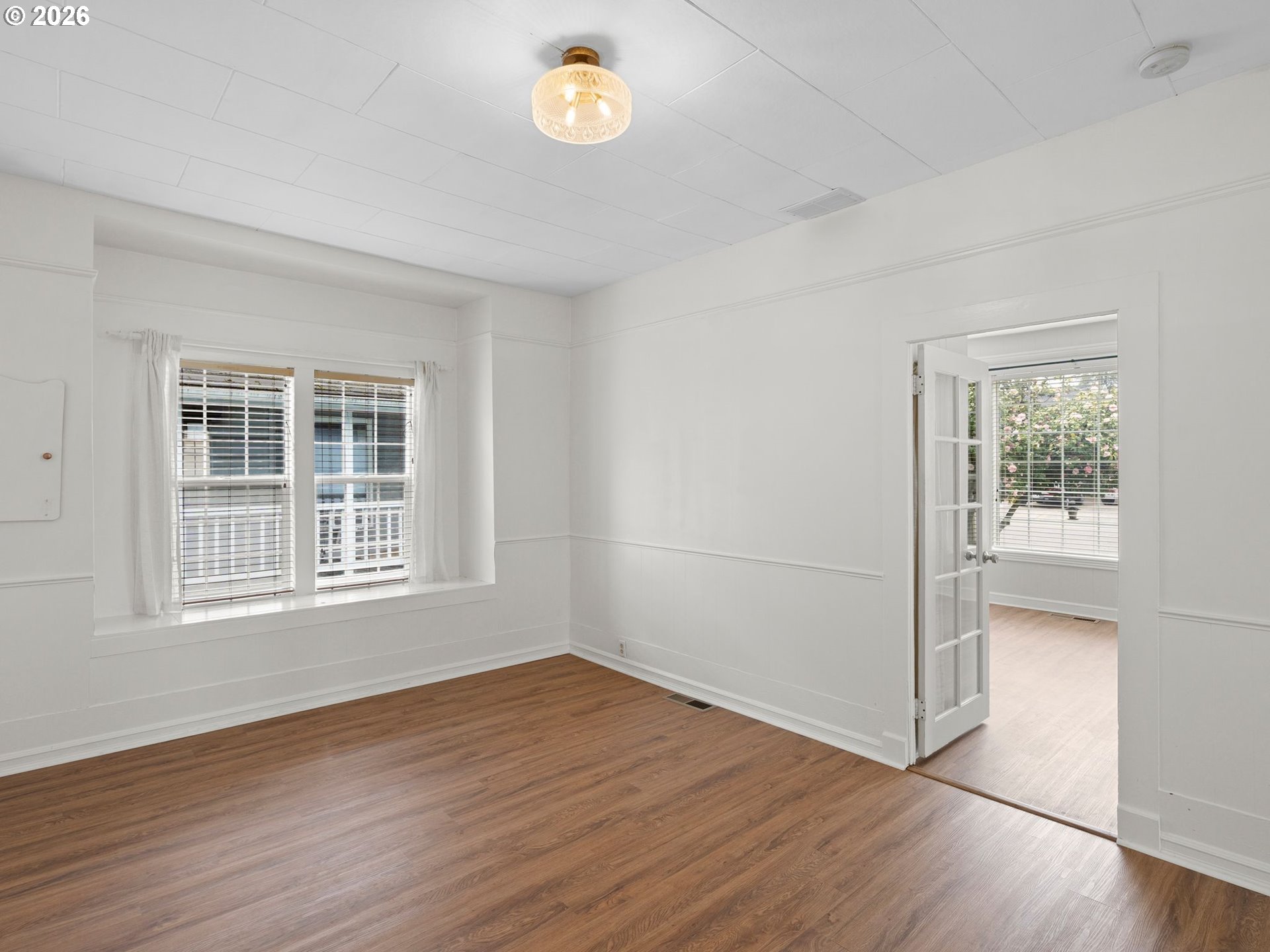 204 South Main Street Newberg, OR 97132 - Photo 6 of 28 an empty room with wooden floor and windows