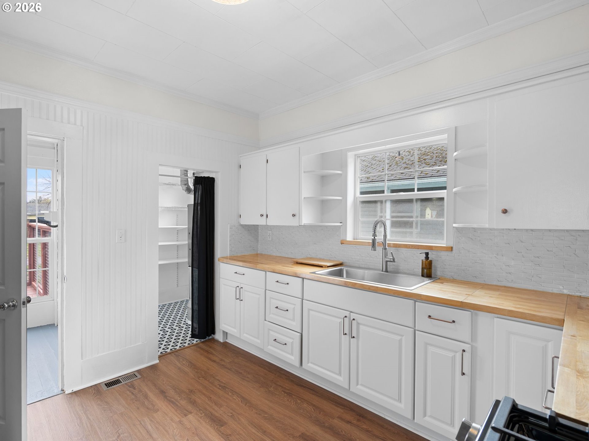 204 South Main Street Newberg, OR 97132 - Photo 10 of 28 a kitchen with white cabinets and sink