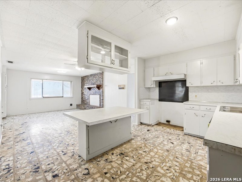 134 Robinhood Kenedy, TX 78119 - Photo 11 of 26 a kitchen with a stove a sink and a refrigerator