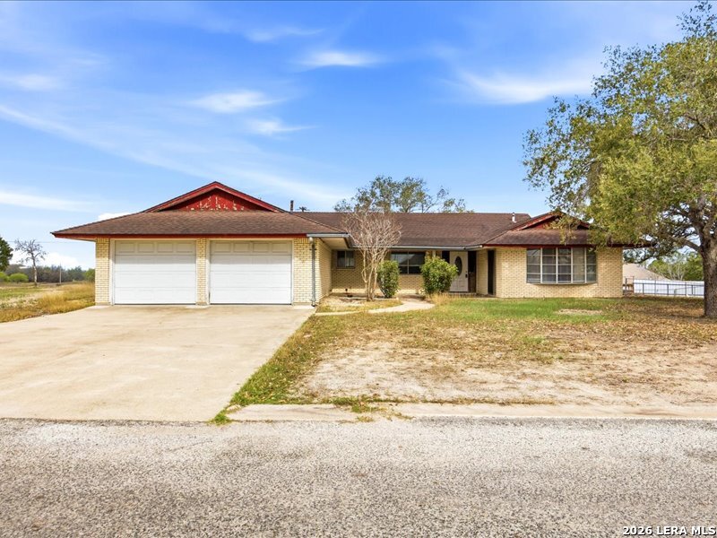 134 Robinhood Kenedy, TX 78119 - Photo 24 of 26 a front view of a house with a garden