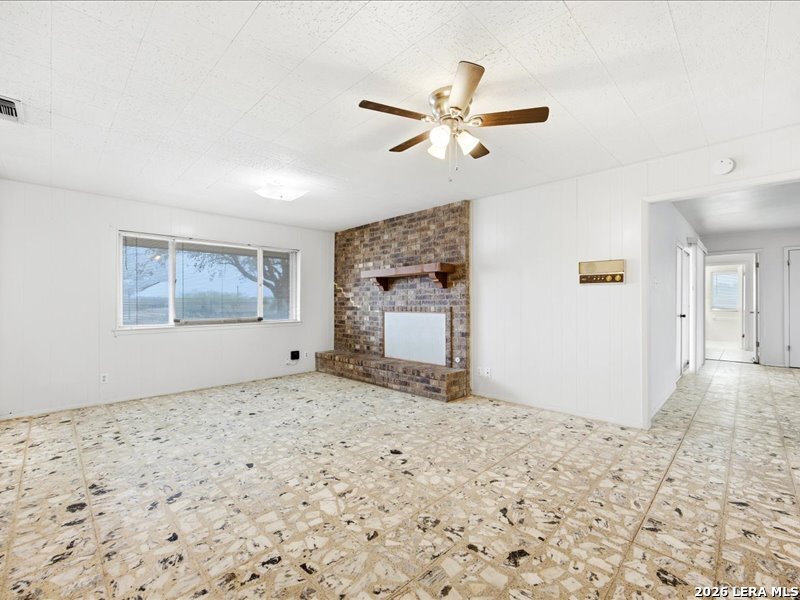 134 Robinhood Kenedy, TX 78119 - Photo 8 of 26 a view of a livingroom with wooden floor and a large window