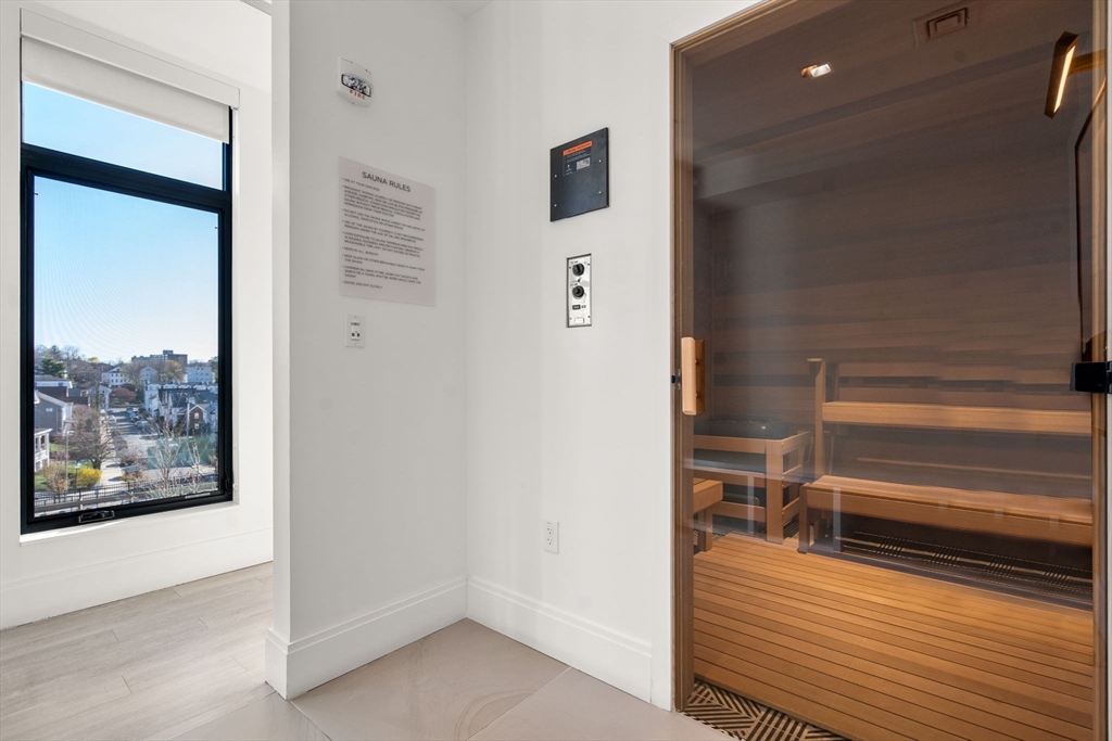 191 Washington Street, Unit 615 Boston, MA 02135 - Photo 22 of 23 a view of a hallway with wooden floor and entryway