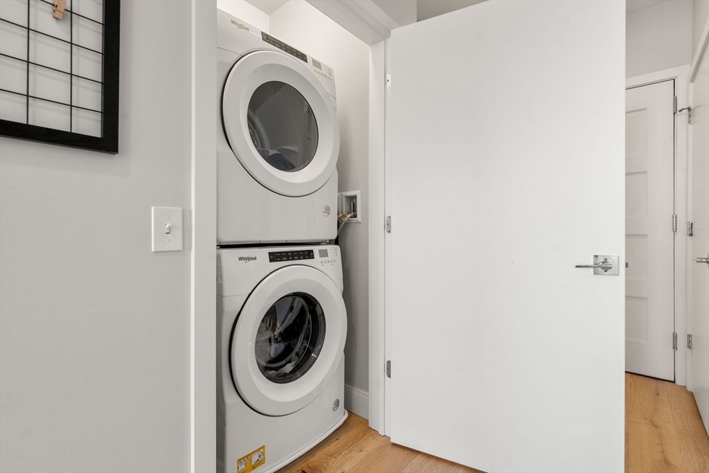 191 Washington Street, Unit 615 Boston, MA 02135 - Photo 6 of 23 a utility room with dryer and washer