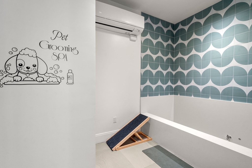 191 Washington Street, Unit 615 Boston, MA 02135 - Photo 10 of 23 a bathroom with a bathtub and shower