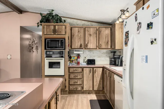 a kitchen with stainless steel appliances a stove a refrigerator and cabinets