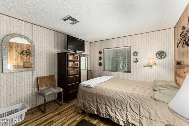 a bedroom with a bed and a chair