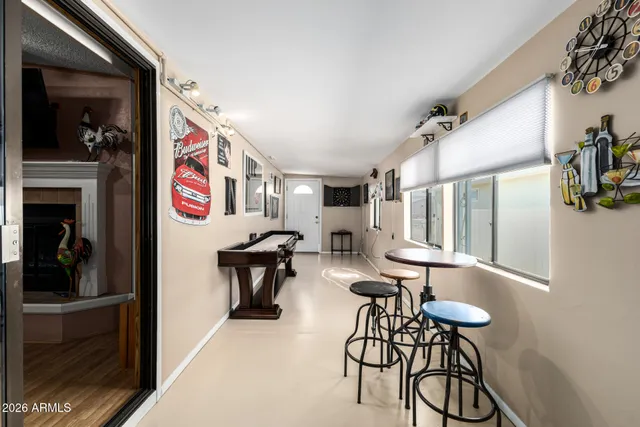 a very nice looking room with many windows and furniture