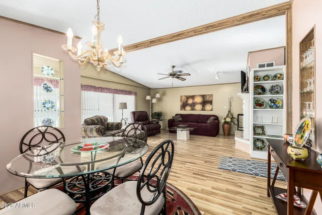 a view of a dining room with furniture wooden floor and chandelier
