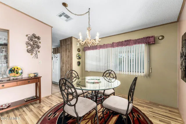 a view of a dining room with furniture and chandelier