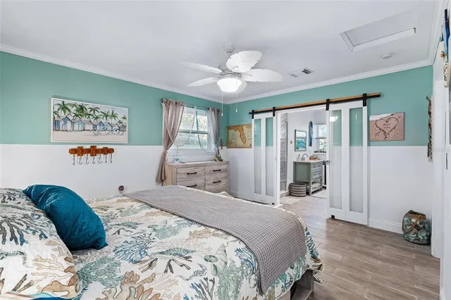 a bedroom with a bed mirror and a window