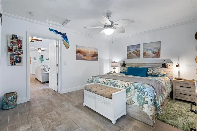 a spacious bedroom with a bed and a chandelier