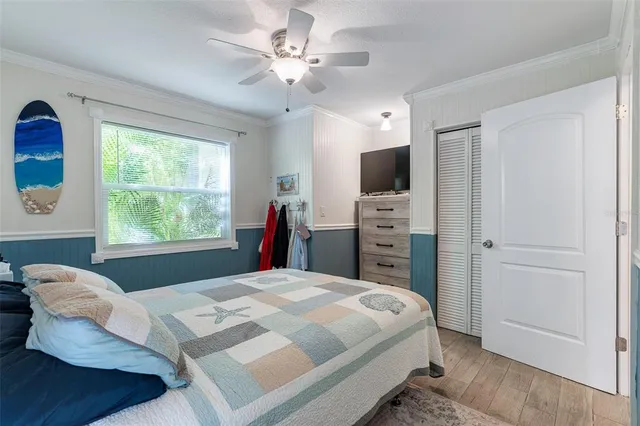 a bedroom with a bed dresser and a window