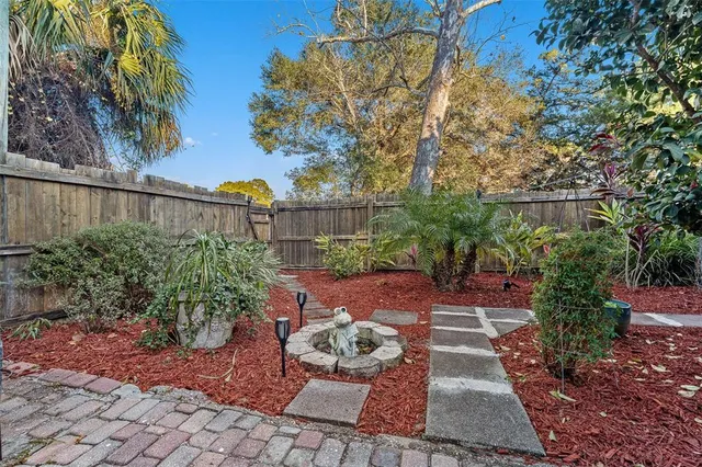 a view of a backyard with plants and a patio