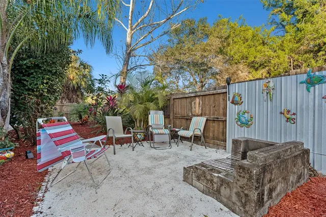 an outdoor sitting area with couch and a fire pit