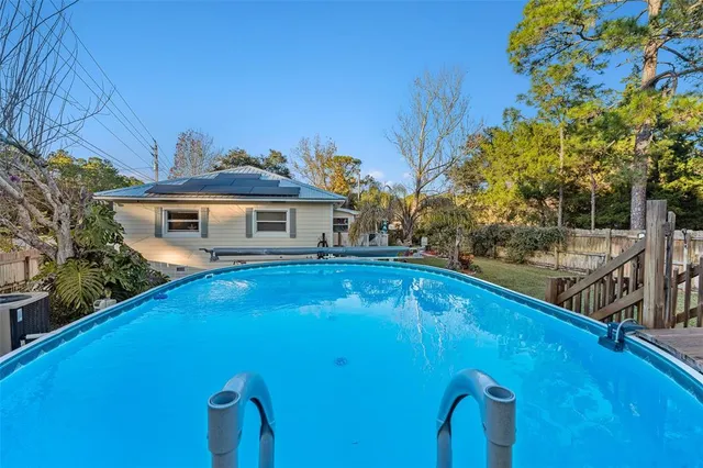 a view of house with a swimming pool