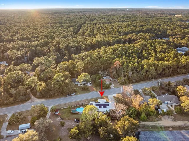 an aerial view of a houses with a yard