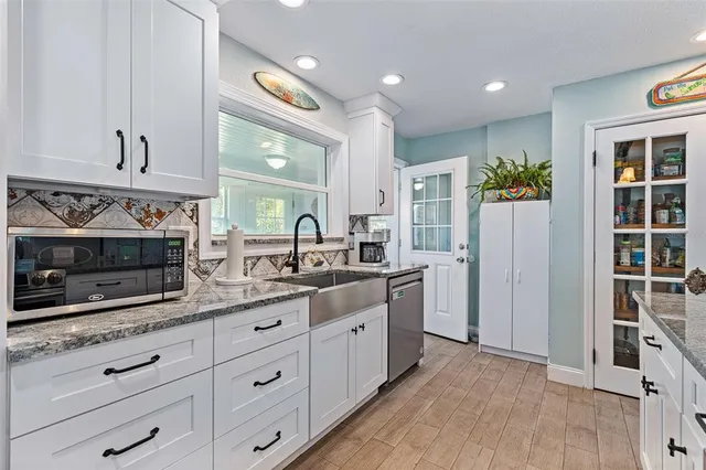 a spacious bathroom with a granite countertop sink and a mirror