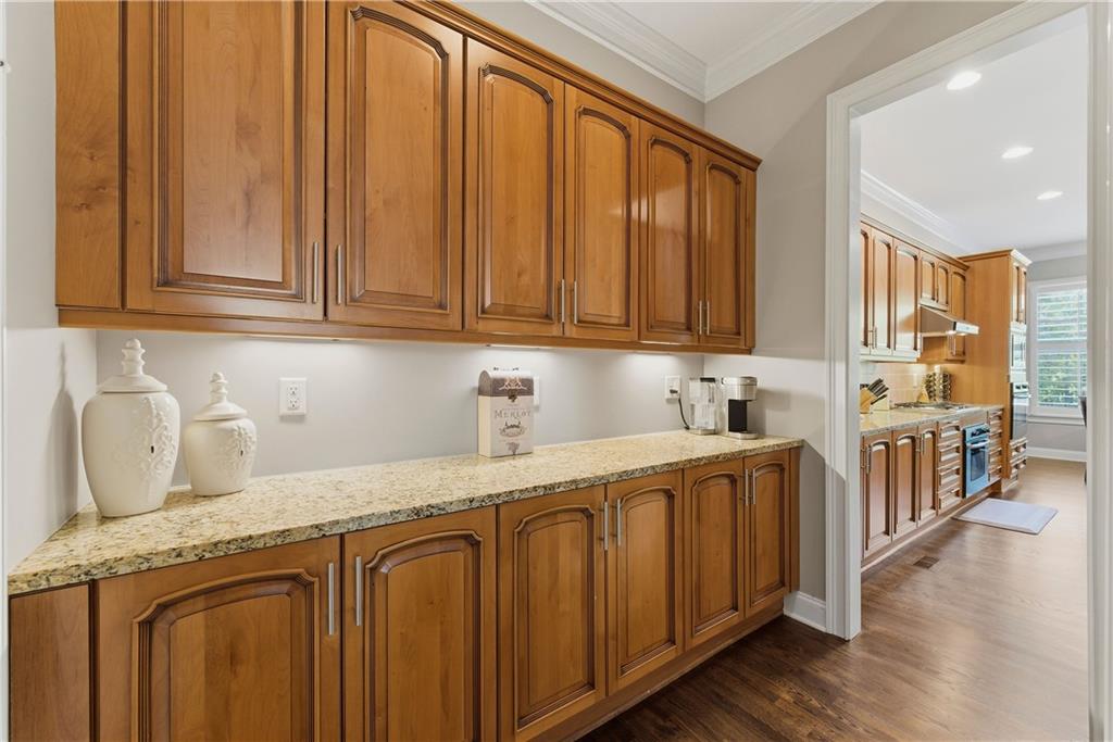 2398 St Davids Square, Unit 16 Kennesaw, GA 30152 - Photo 13 of 48 a kitchen with stainless steel appliances granite countertop a sink a stove cabinets and wooden floor