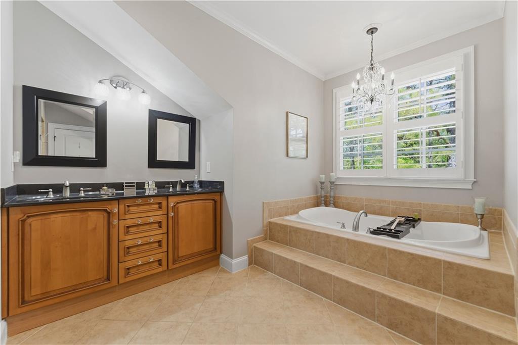 2398 St Davids Square, Unit 16 Kennesaw, GA 30152 - Photo 30 of 48 a spacious bathroom with sinks mirror and a bathtub