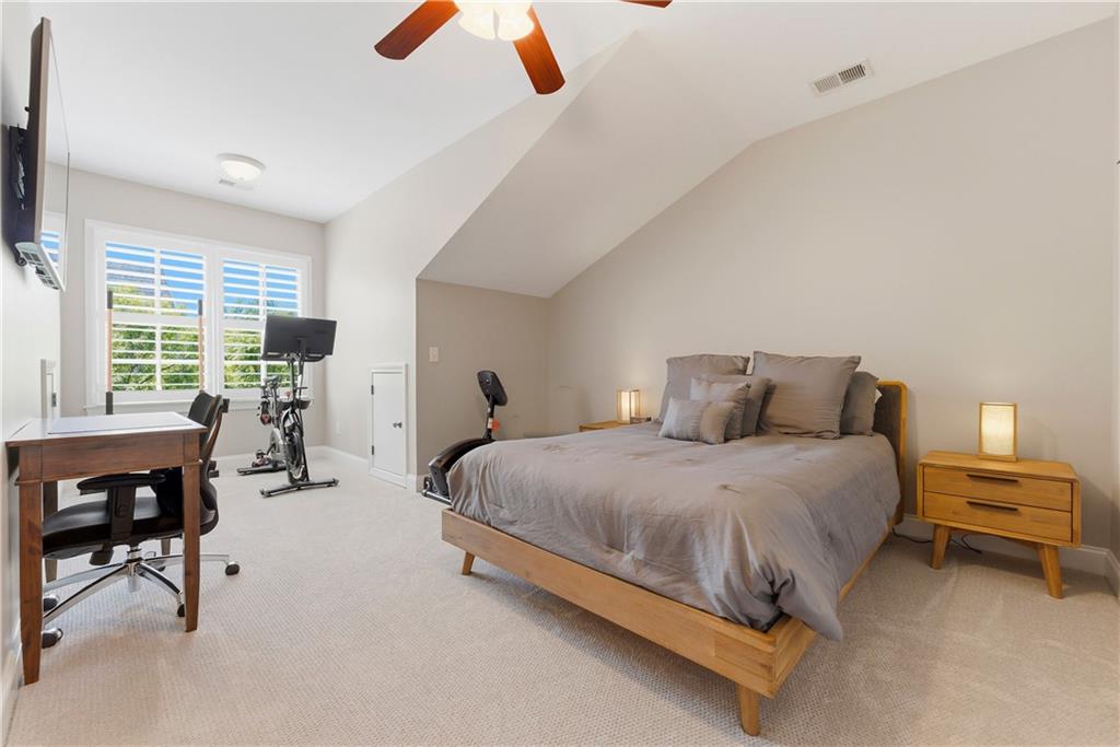 2398 St Davids Square, Unit 16 Kennesaw, GA 30152 - Photo 34 of 48 a spacious bedroom with a bed a table and chair