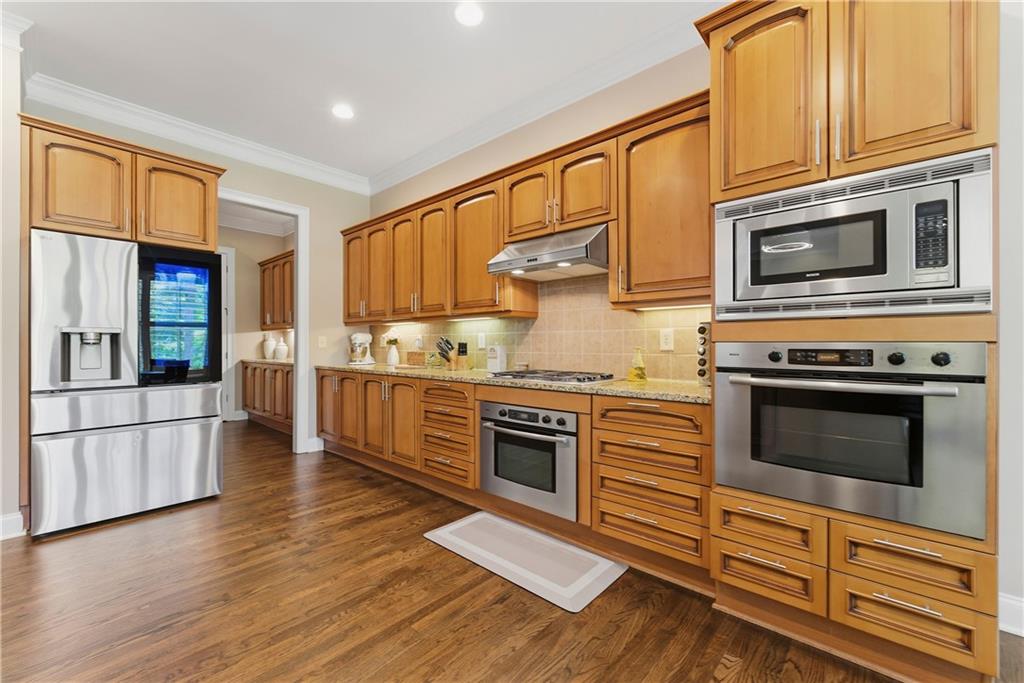2398 St Davids Square, Unit 16 Kennesaw, GA 30152 - Photo 10 of 48 a kitchen with stainless steel appliances granite countertop a stove top oven and a refrigerator