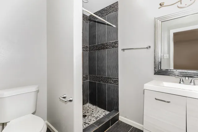 a bathroom with a sink toilet and shower