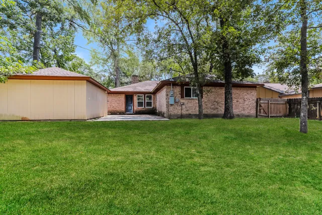 a view of house with backyard