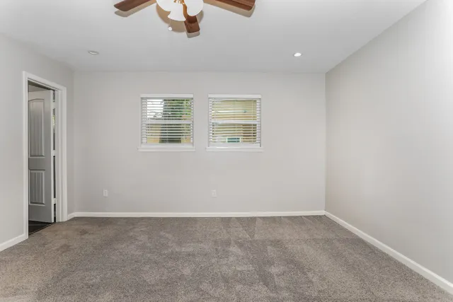 an empty room with ceiling fan