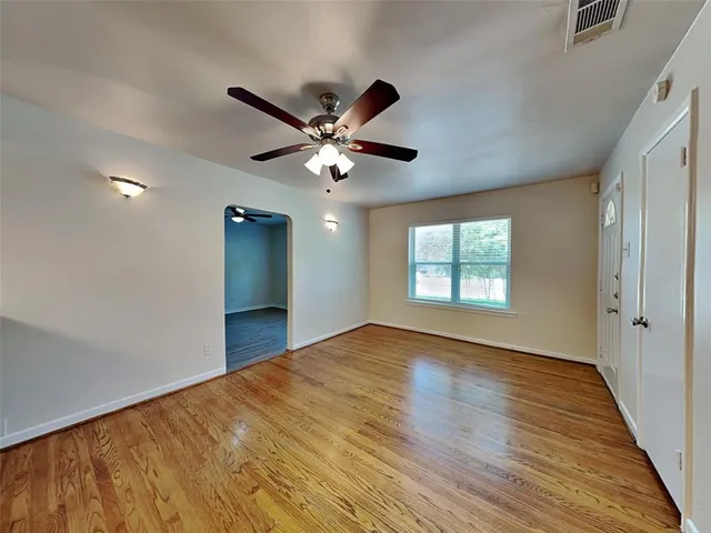 wooden floor in an empty room with a window