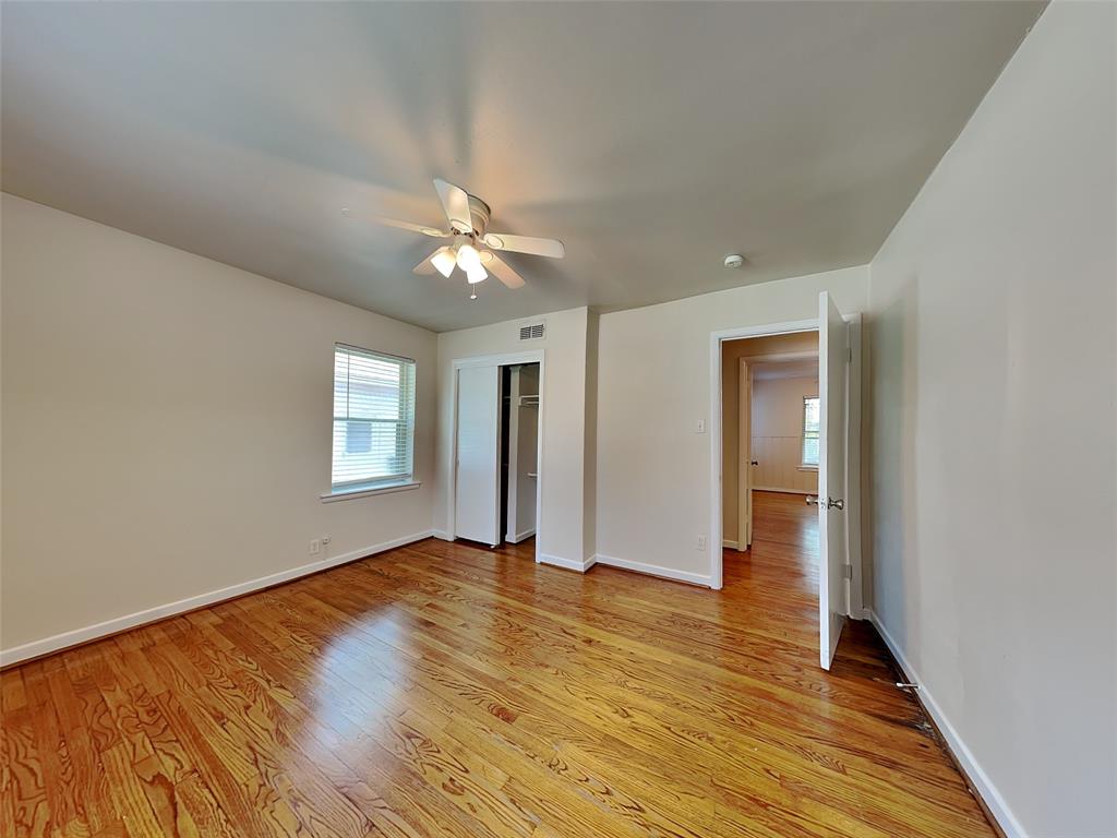 1002 Noble Avenue Carrollton, TX 75006 - Photo 10 of 16 a view of an empty room with window and wooden floor