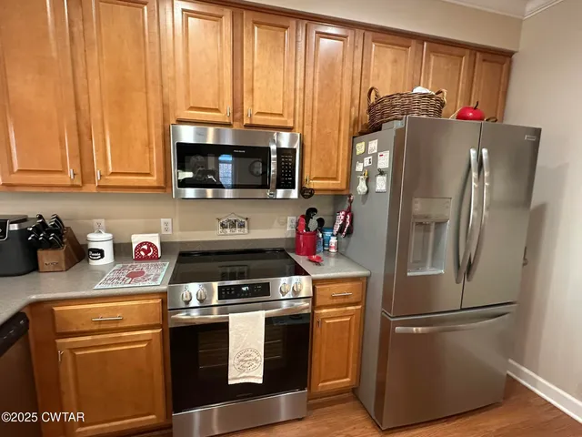 a kitchen with a refrigerator stove and microwave