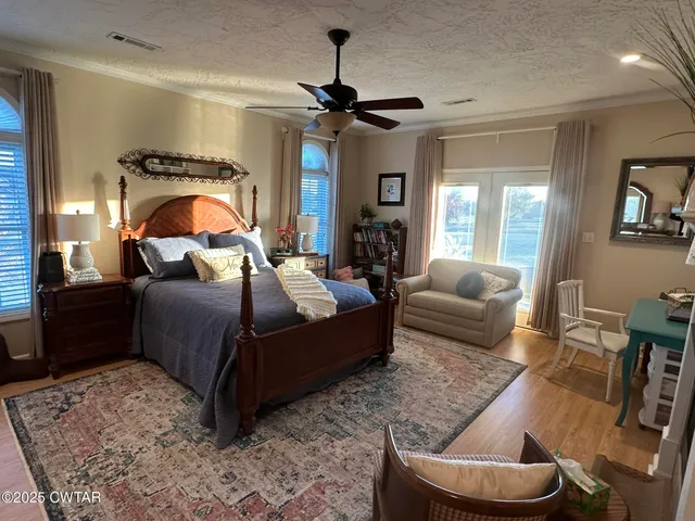 a bedroom with a bed couch and window