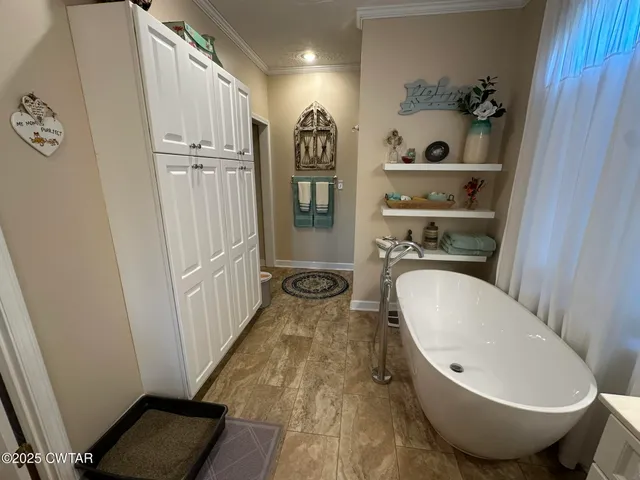 a view of a bathroom with tub and shower