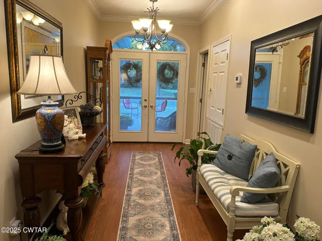 a living room with furniture and a chandelier