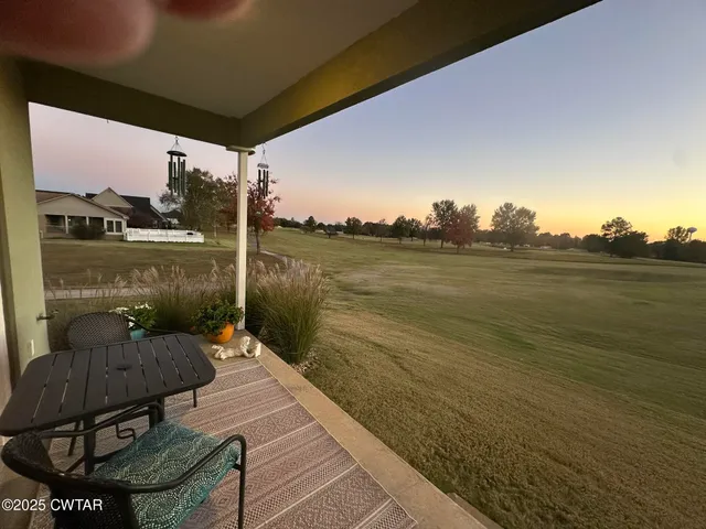 a front view of a house with lake outdoor seating and patio