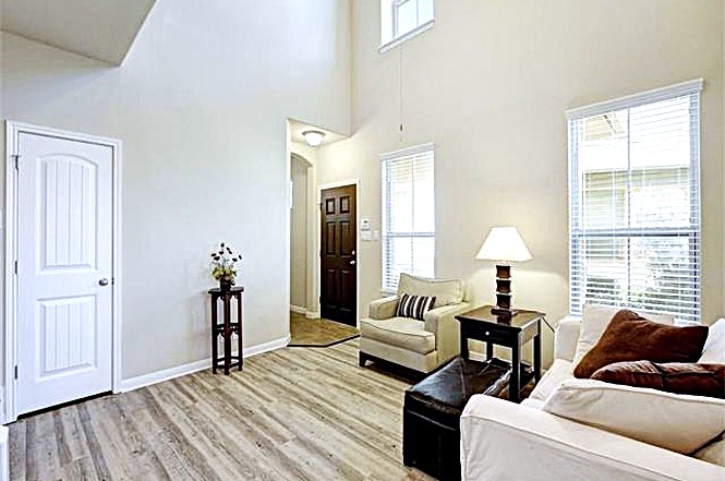 14001 Avery Ranch Boulevard, Unit 801 Austin, TX 78717 - Photo 4 of 26 The open-concept living area features a soaring vaulted ceiling and wide plank flooring.