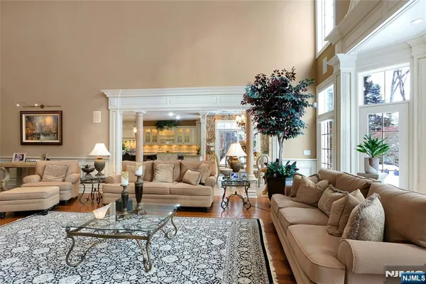 a living room with furniture and kitchen view