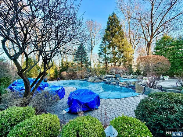 a living room with fireplace furniture and a rug