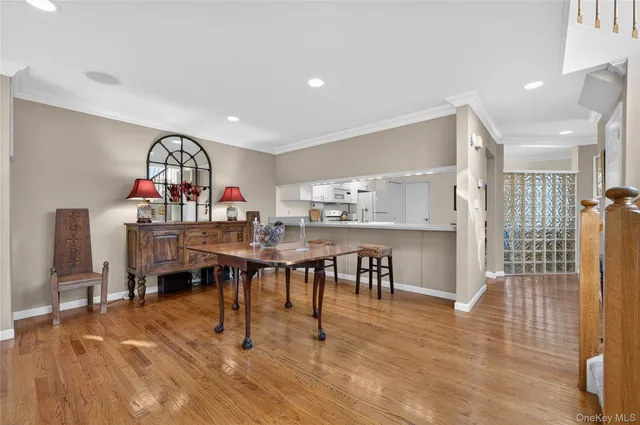 a view of a a dining room with furniture window and wooden floor