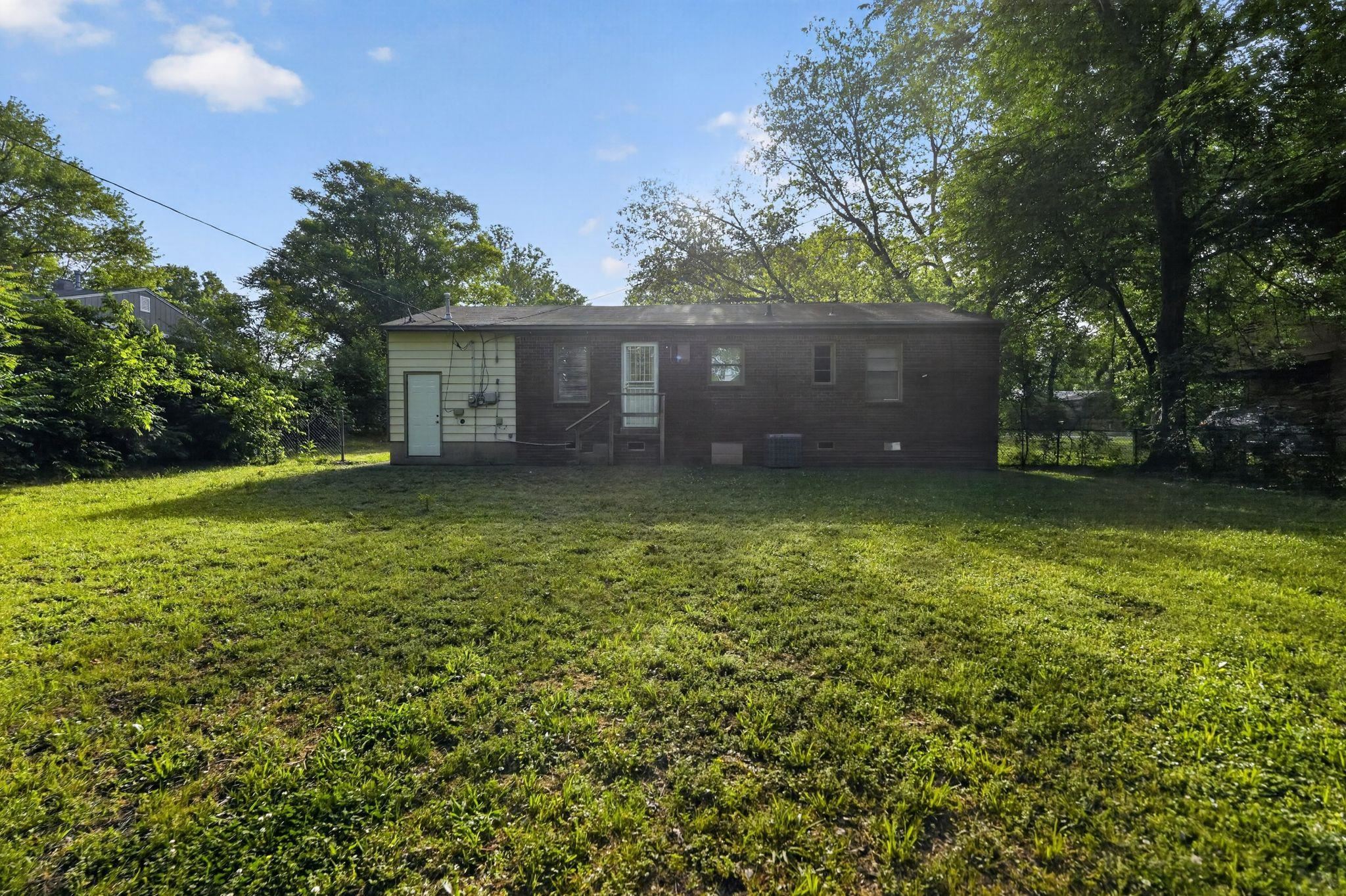 4955 Stacey Road Memphis, TN 38109 - Photo 11 of 35 Expansive rear yard featuring green lawn