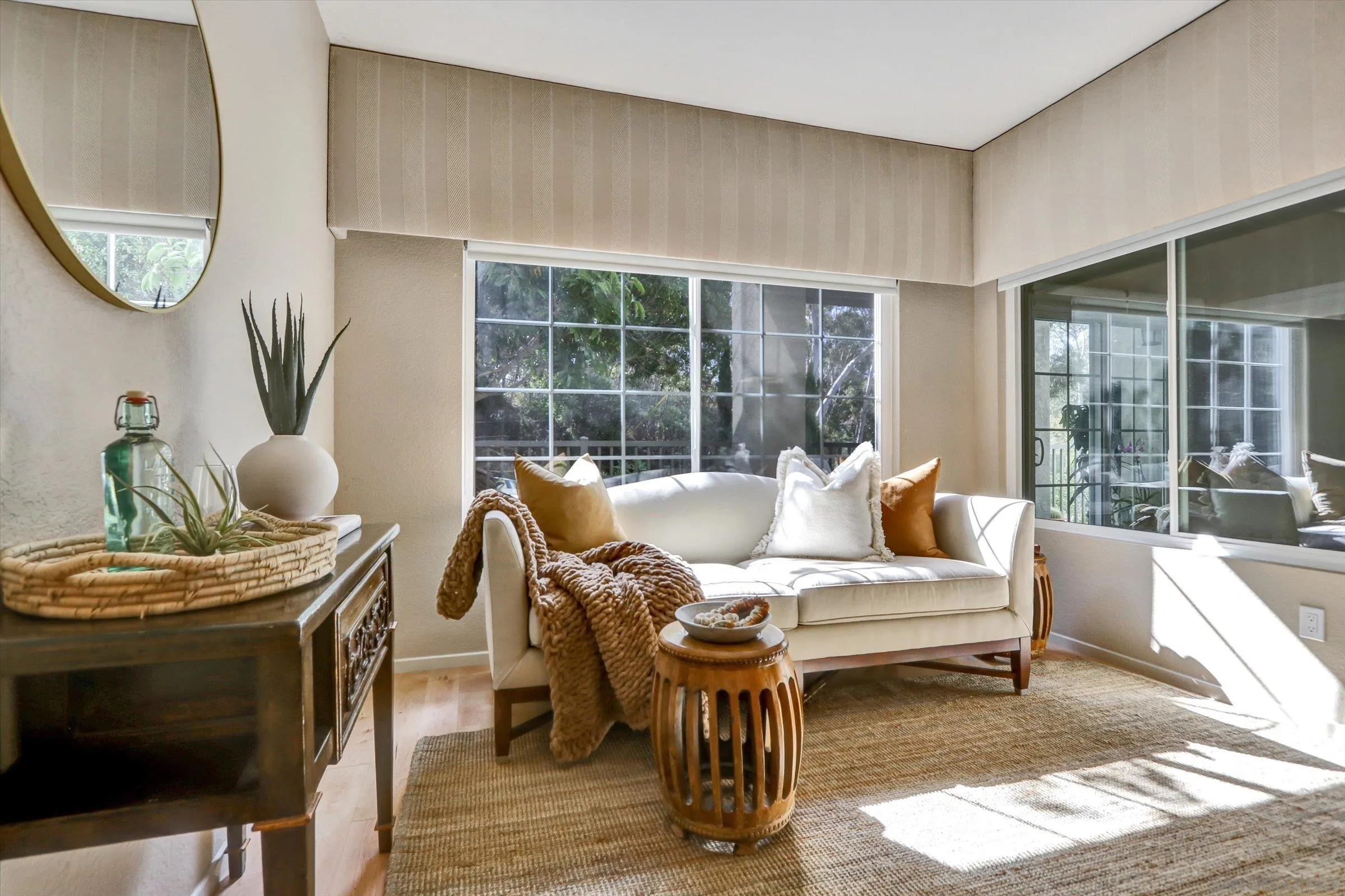 a living room with furniture a fireplace and a floor to ceiling window