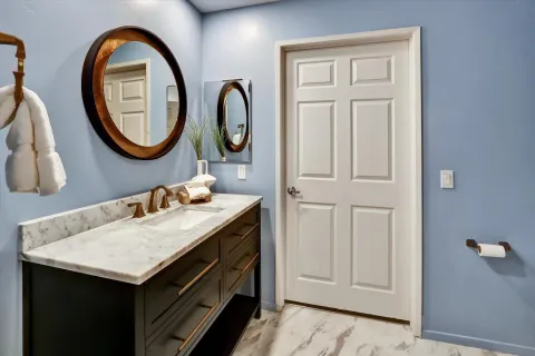 a bathroom with a sink and a mirror