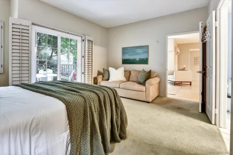 a spacious bedroom with a bed and a large window