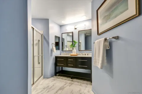 a bathroom with a double vanity sink and mirror