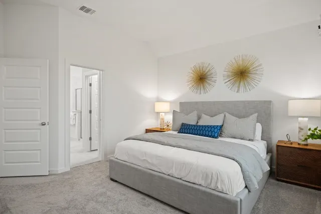 a bedroom with a bed and a potted plant