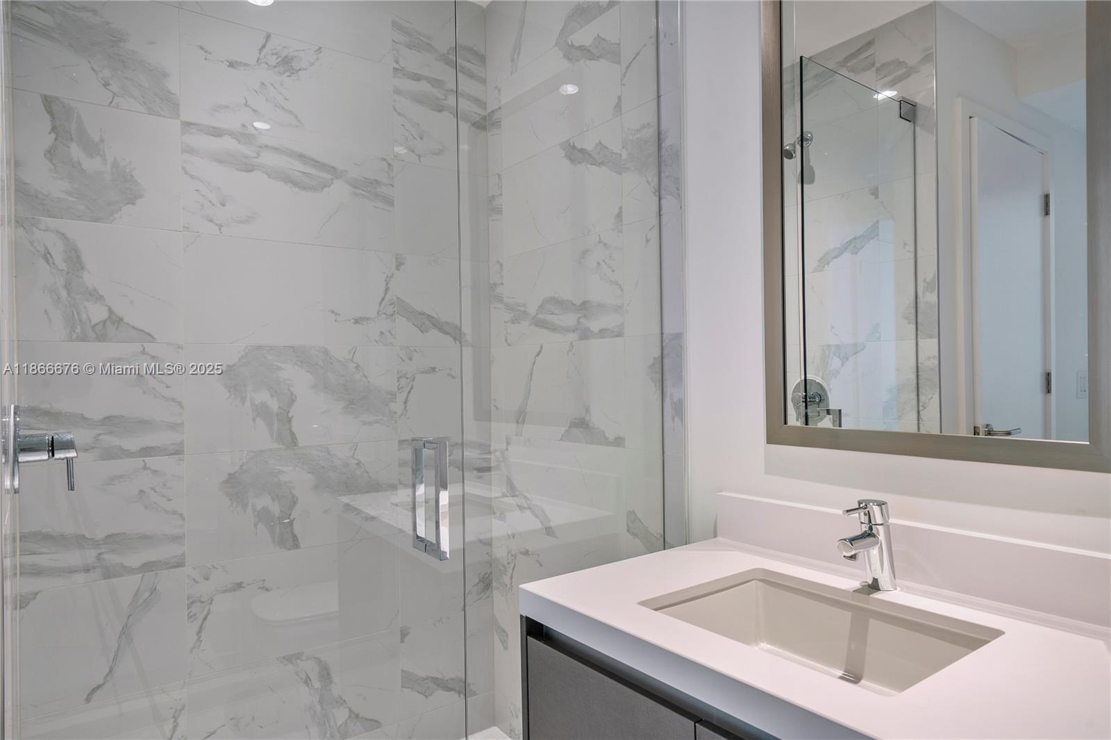 851 Northeast 1st Avenue, Unit 3203 Miami, FL 33132 - Photo 14 of 48 a bathroom with a sink and a mirror