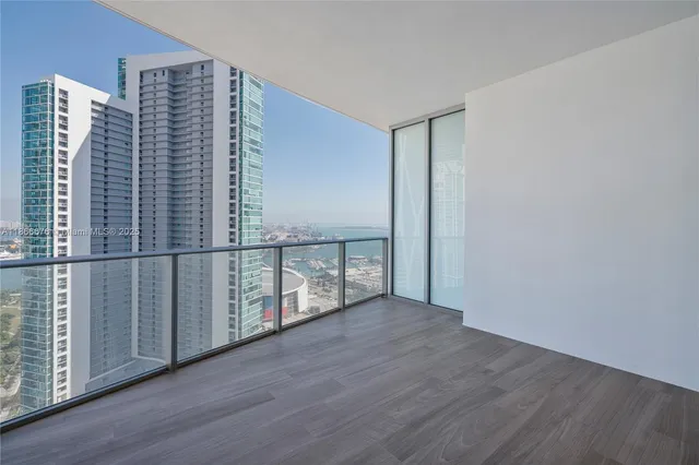a view of kitchen with sink and refrigerator