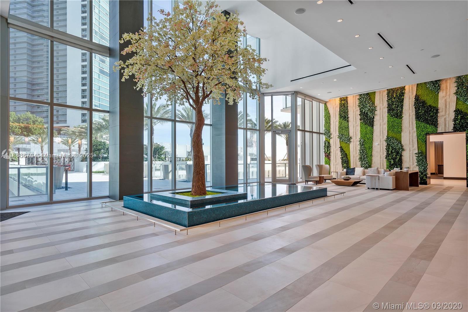 851 Northeast 1st Avenue, Unit 3203 Miami, FL 33132 - Photo 31 of 48 a view of a room with floor to ceiling windows and wooden floor