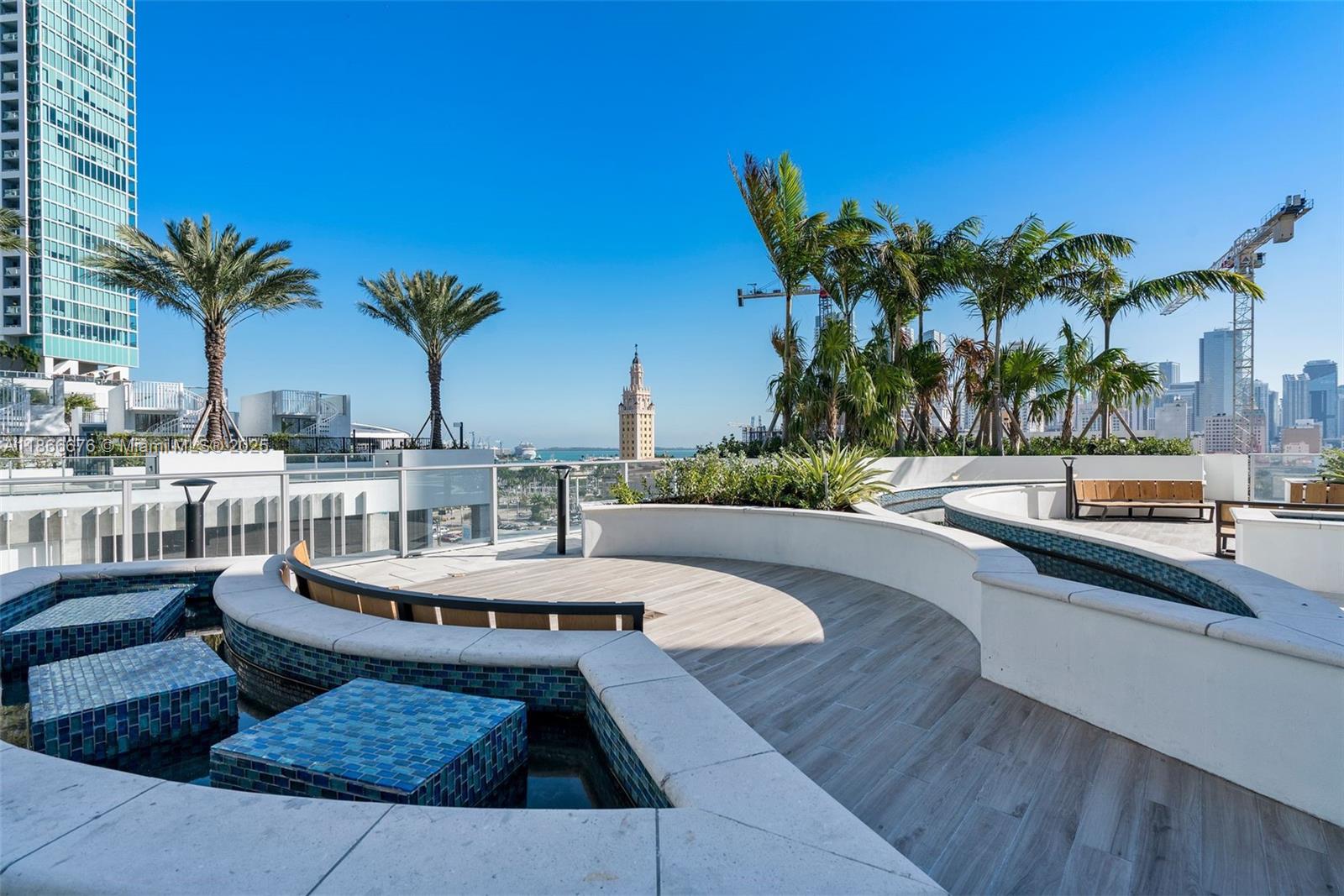 851 Northeast 1st Avenue, Unit 3203 Miami, FL 33132 - Photo 37 of 48 a view of a swimming pool with outdoor seating and plants