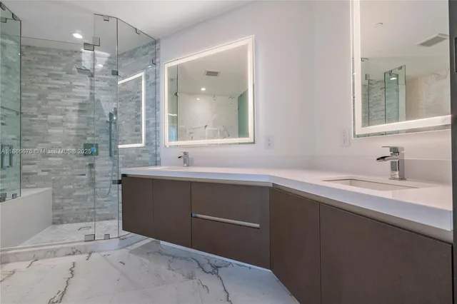 a bathroom with a bathtub and a shower
